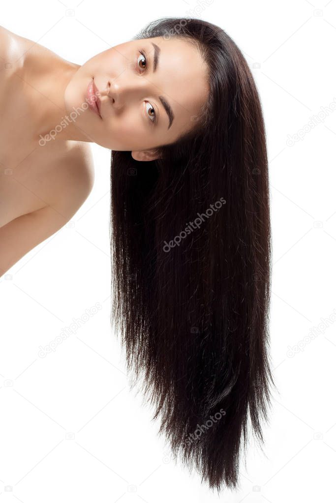 portrait of attractive asian model with strong and healthy hair looking at camera isolated on white