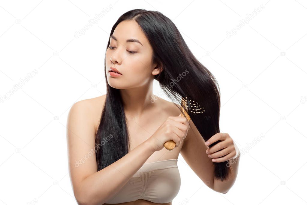 portrait of beautiful asian woman brushing hair isolated on white