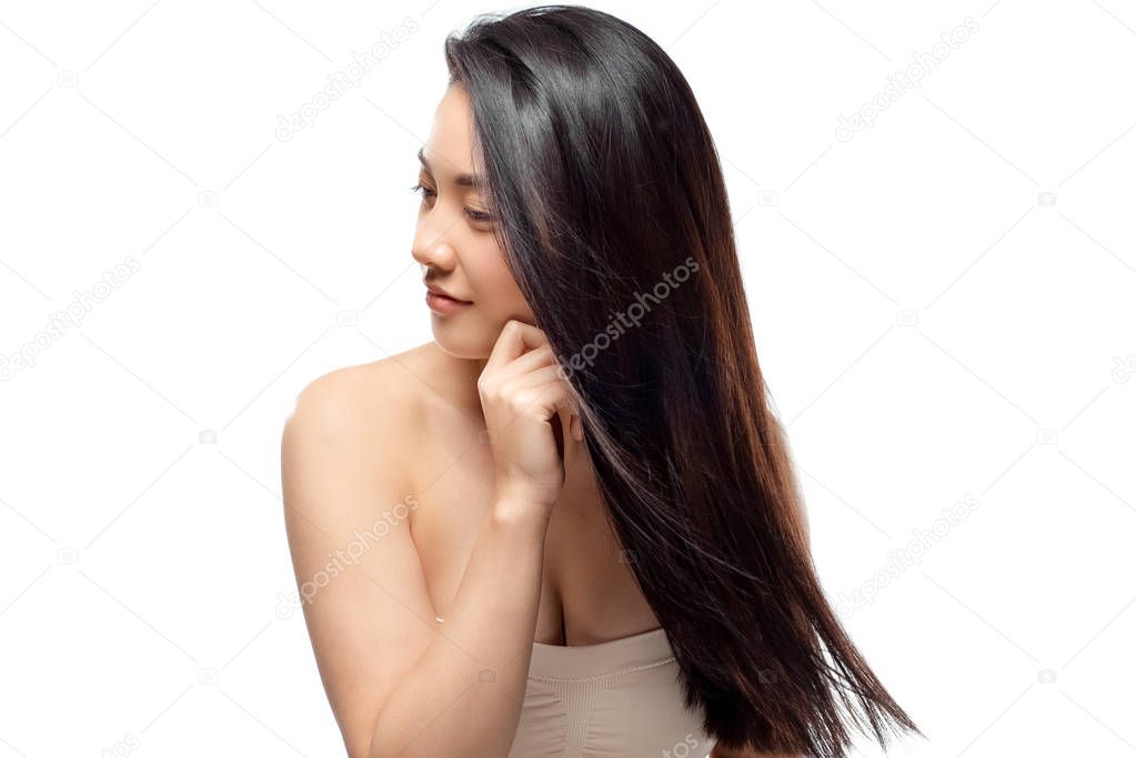 portrait of asian model with healthy and shiny hair posing isolated on white