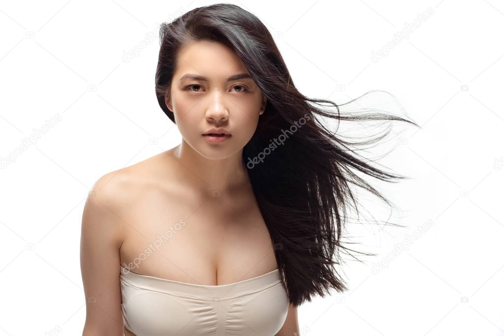 portrait of young asian woman with beautiful and healthy hair looking at camera isolated on white