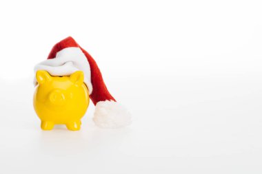 yellow piggy bank in santa hat isolated on white   clipart