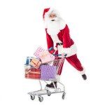 Santa claus carrying trolley with pile of gift boxes isolated on white background