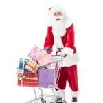 Verbaasd santa claus trolley uitvoering met stapel geschenkdozen geïsoleerd op witte achtergrond