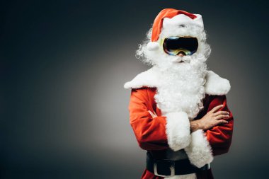 kar maskesi ayakta çapraz kolları üzerinde gri arka plan izole olan kendine güvenen Noel Baba