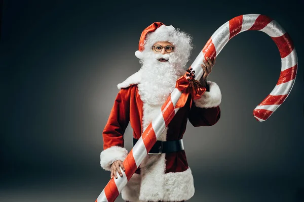 Serious Santa Claus Costume Standing Big Striped Christmas Stick Isolated — Stock Photo, Image