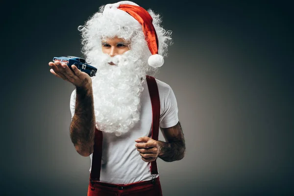 Serious Santa Claus Holding Toy Car Hand Palm Standing Isolated — Free Stock Photo