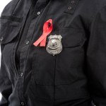 Colpo ritagliato di agente di polizia femminile con aiuti consapevolezza nastro rosso isolato su bianco