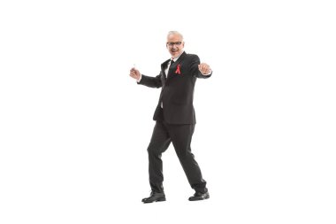 funny mature businessman in suit with aids awareness red ribbon dancing isolated on white clipart