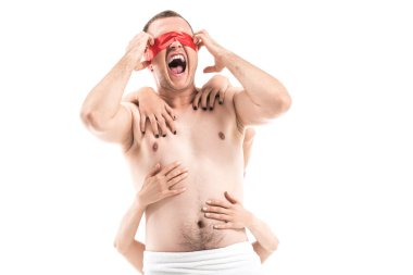 screaming shirtless man with tied eyes and female hands touching him from behind isolated on white, aids concept clipart