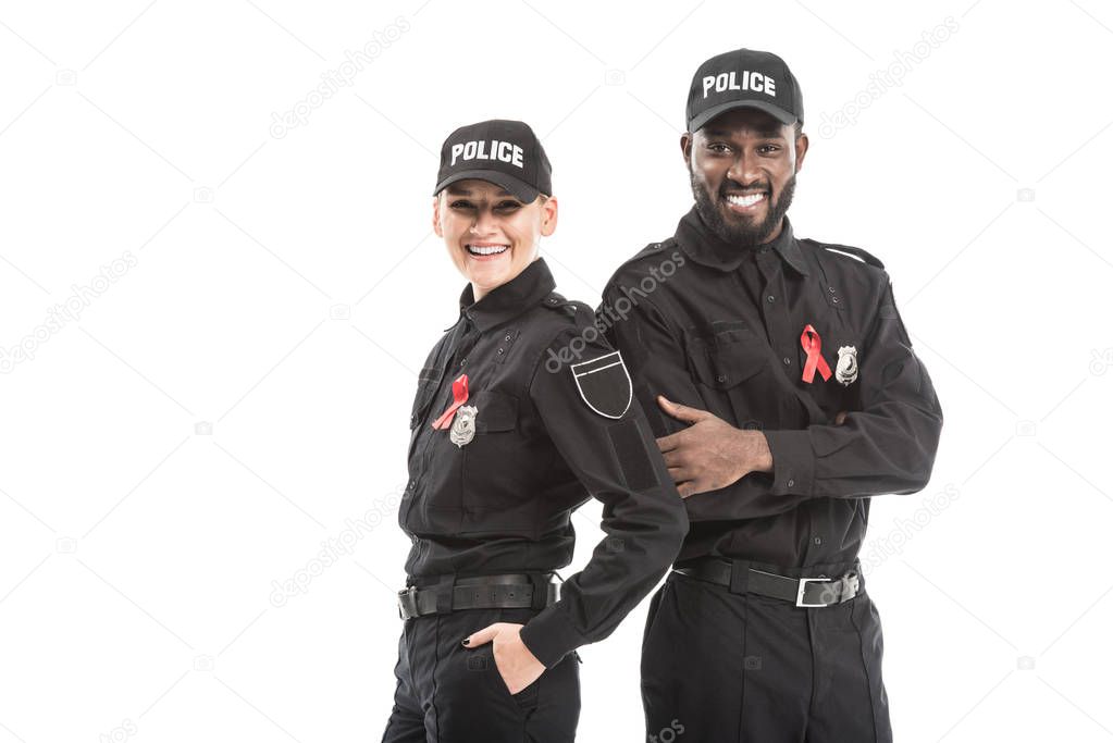 confident police officers with aids awareness red ribbons looking at camera isolated on white