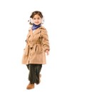 Happy little child in stylish trench coat listening music with headphones isolated on white