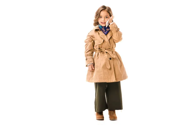 Beautiful Little Child Trench Coat Talking Phone Looking Cameraisolated White — Free Stock Photo