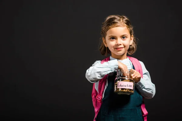 Schoolgirl Backpack Holding Glass Jar Savings Education Isolated Black — Stock Photo, Image