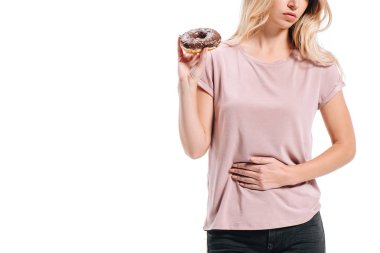 cropped image of woman showing stomach pain and holding doughnut isolated on white clipart