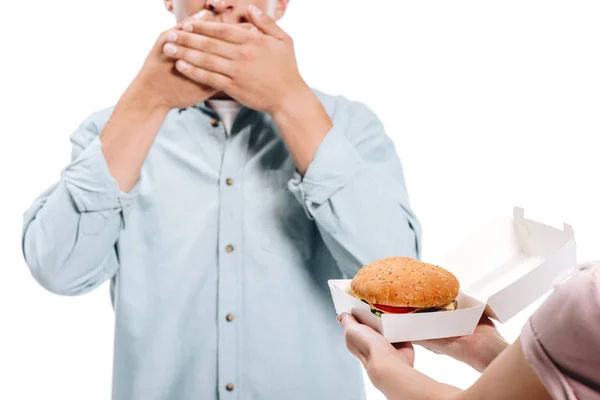 Cropped Image Man Covering Mouth Woman Proposing Burger Isolated White — Free Stock Photo