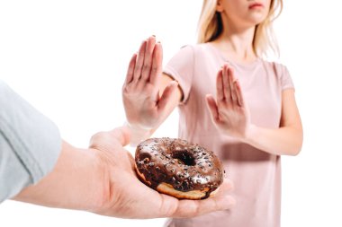 cropped image of woman rejecting chocolate doughnut isolated on white clipart