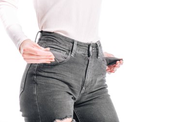 cropped image of girl showing empty jeans pockets isolated on white clipart