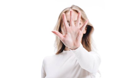 selective focus of blonde woman showing stop sign isolated on white clipart