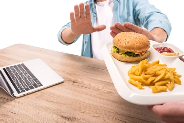 Imagen Recortada Hombre Rechazando Hamburguesa Malsana Papas Fritas Mesa Aislado — Foto de Stock