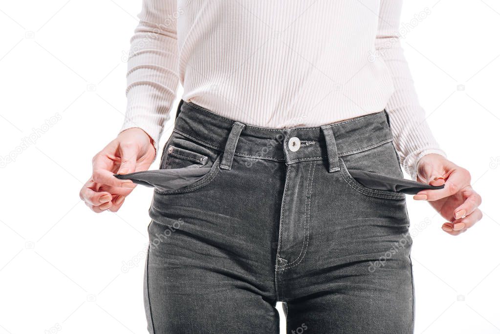 cropped image of woman showing empty pockets isolated on white