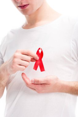 cropped image of man showing red ribbon on shirt isolated on white, world aids day concept clipart