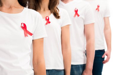 cropped image of people standing with red ribbons on shirts isolated on white, world aids day concept clipart