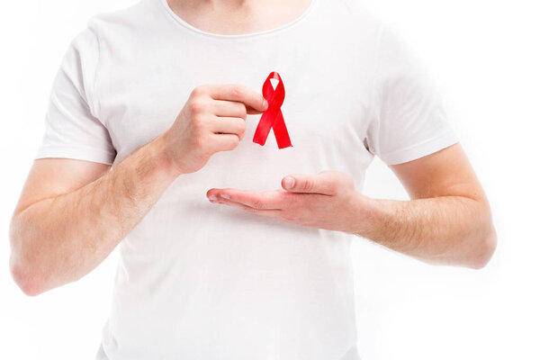 midsection of man showing red ribbon on shirt isolated on white, world aids day concept