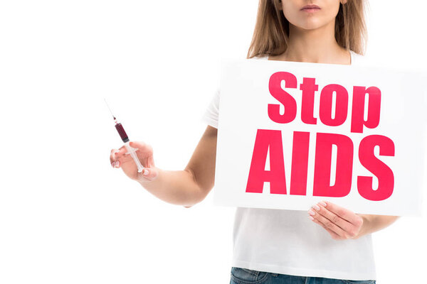 cropped image of woman holding syringe with blood and card with stop aids text isolated on white, world aids day concept