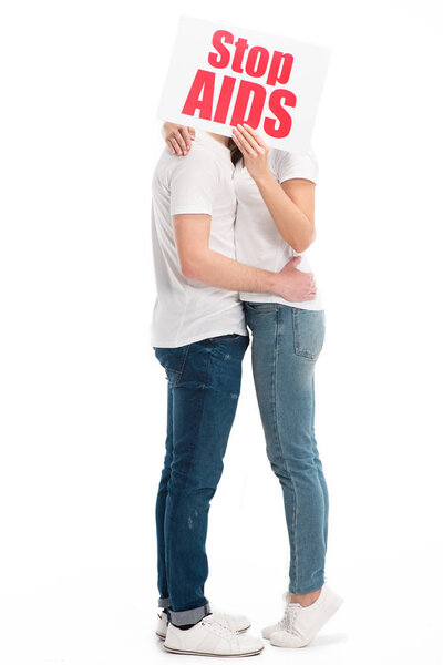 couple kissing and covering faces with card with stop aids text isolated on white, world aids day concept