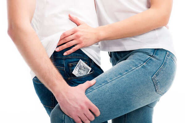 cropped image of heterosexual couple hugging, condom in pocket isolated on white, world aids day concept