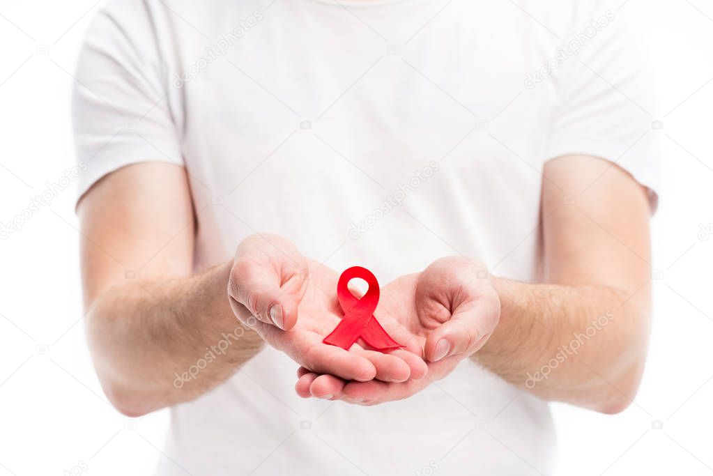 cropped image of man showing red ribbon in hands isolated on white, world aids day concept