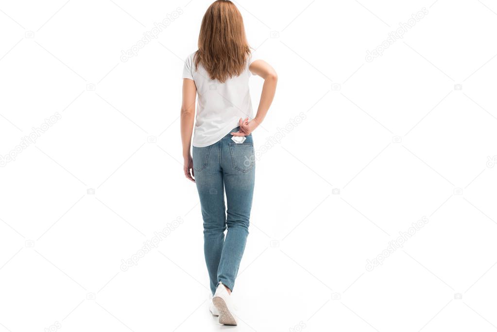 back view of woman taking condom from pocket isolated on white, world aids day concept