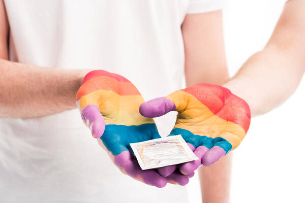cropped image of gay couple holding condom isolated on white, world aids day concept