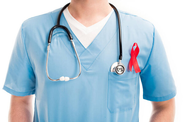 cropped image of doctor standing with red ribbon and stethoscope isolated on white, world aids day concept