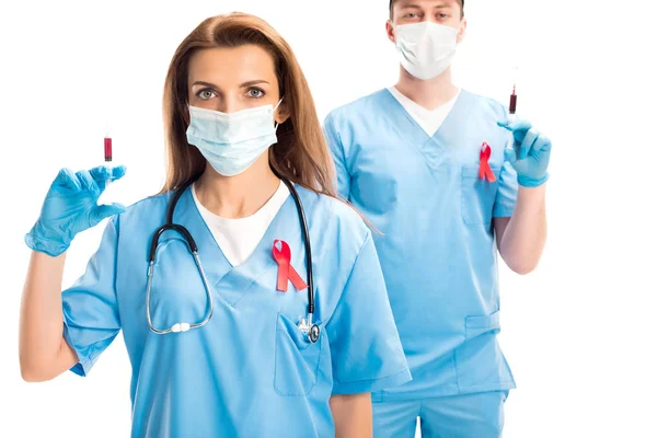 Doctors Medical Masks Red Ribbons Holding Syringes Blood Isolated White — Stock Photo, Image