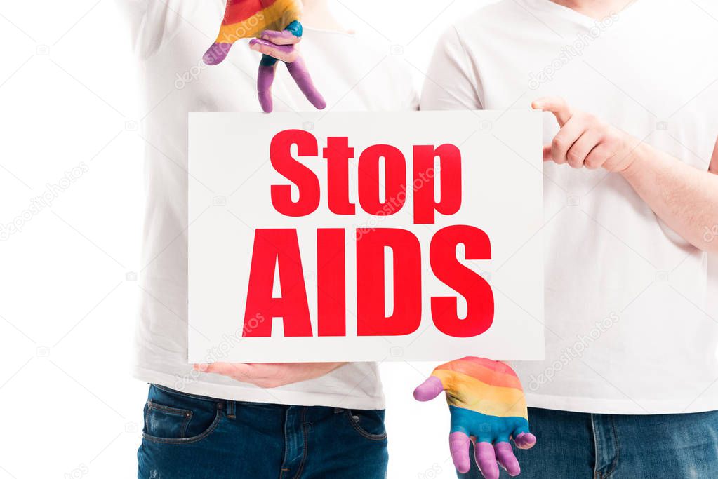 cropped image of gay couple holding card with stop aids text isolated on white, world aids day concept