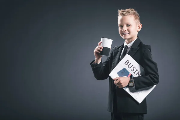 Portrait Smiling Boy Businessman Suit Coffee Business Newspaper Grey Backdrop — Stock Photo, Image