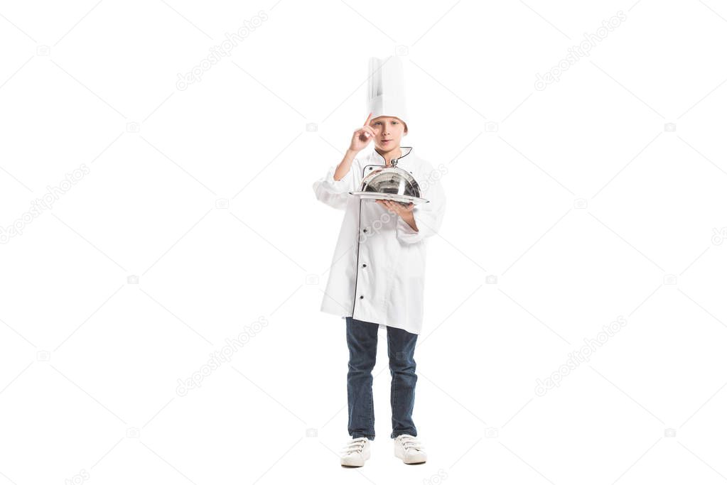 boy in chef uniform and hat holding metal serving tray isolated on white