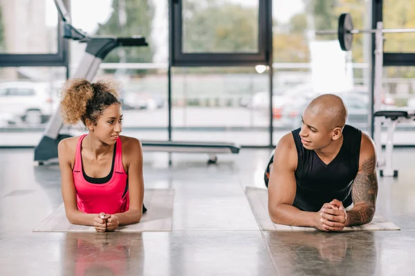 Alegre Afroamericano Pareja Atletas Mirándose Mientras Descansa Colchonetas Fitness Gimnasio — Foto de stock gratis