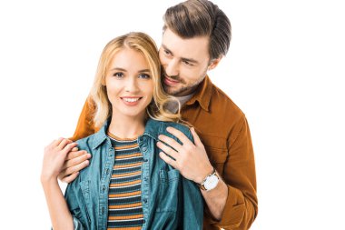 young man embracing girlfriend from behind isolated on white  clipart