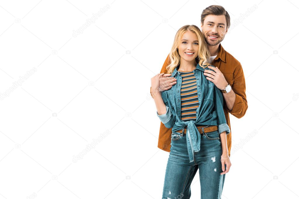 handsome man embracing girlfriend from behind isolated on white 