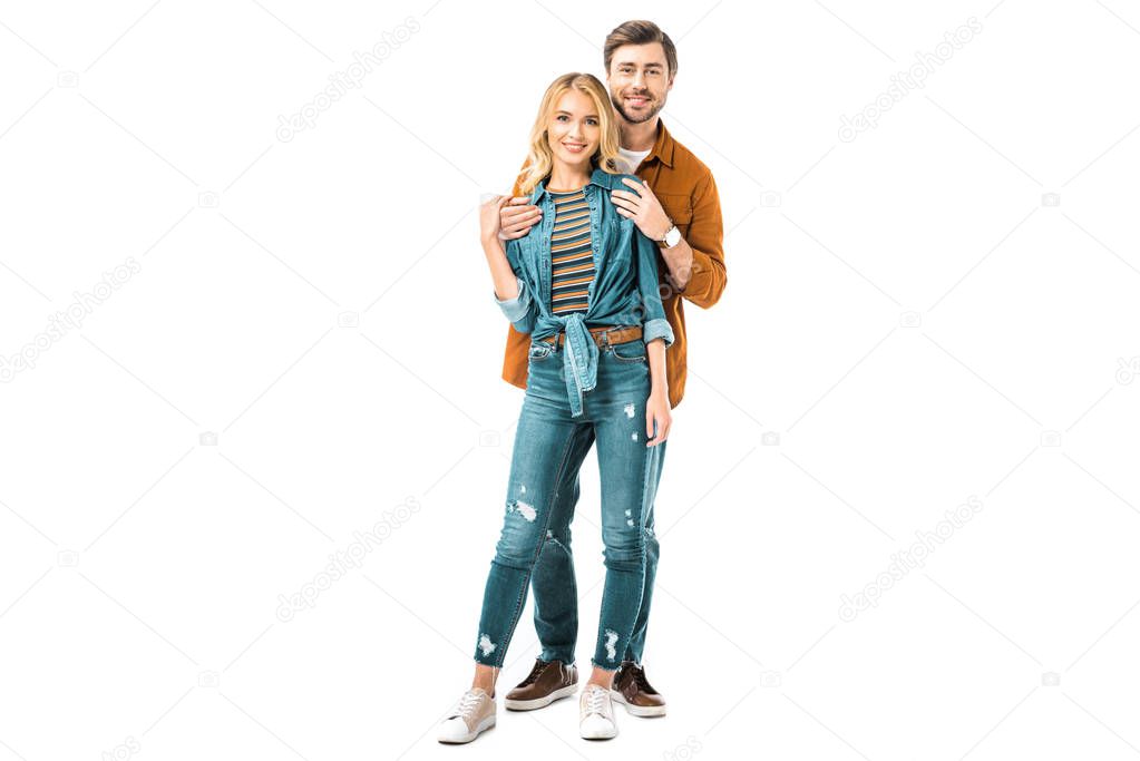 smiling man embracing girlfriend from behind isolated on white 