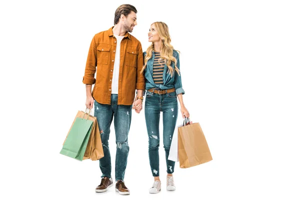 Young Couple Looking Each Other Holding Colorful Paper Bags Isolated — Stock Photo, Image