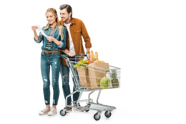 Happy Couple Trolley Full Products Paper Bags Looking Shopping Check — Stock Photo, Image