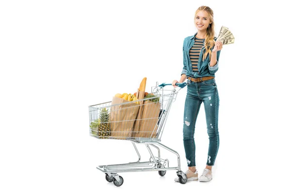 Smiling Girl Standing Shopping Trolley Products Showing Cash Money Isolated — Stock Photo, Image