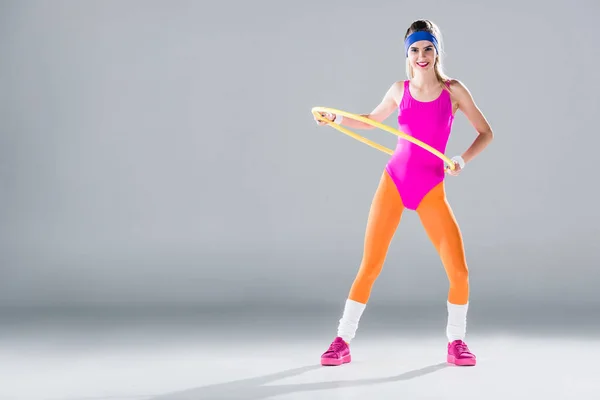 Beautiful Sporty Girl Training Hula Hoop Smiling Camera Grey — Stock Photo, Image