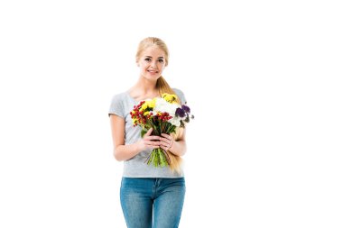 Pretty blonde girl holding flowers and looking at camera clipart