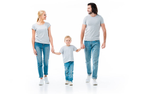 Lovely family holding hands and looking at each other isolated on white