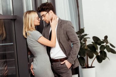 Ofiste, birbirine bakarak sarılma iş adamları yan görünüm flört ve office romance kavramı