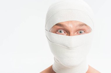 close up of man face covered with white bandages after plastic surgery isolated on white clipart